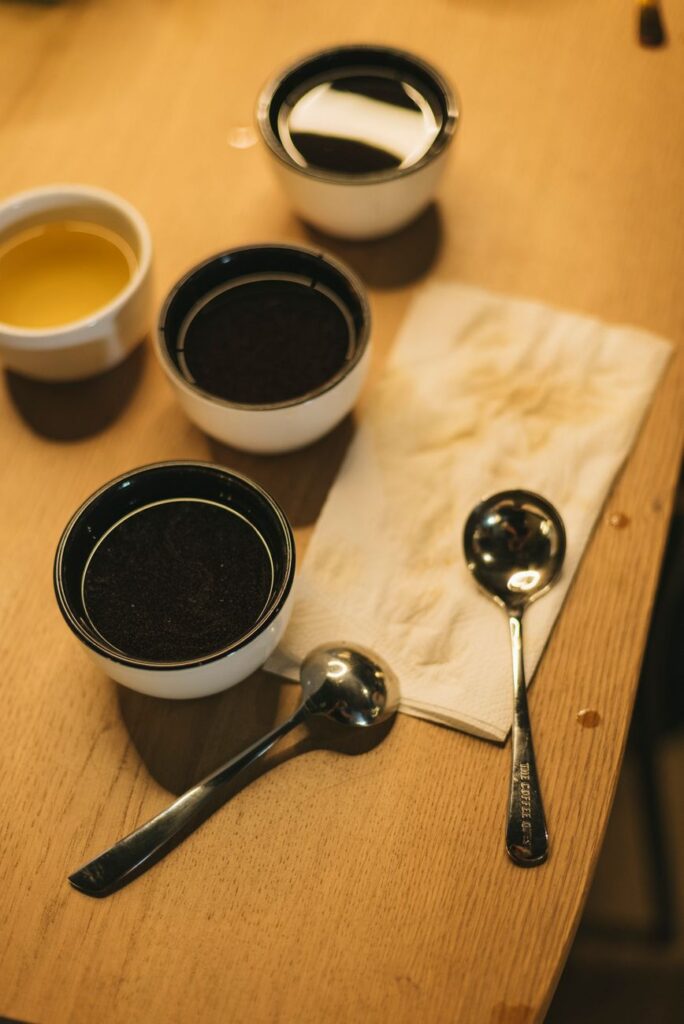 coffee tasting setup with cups and spoons