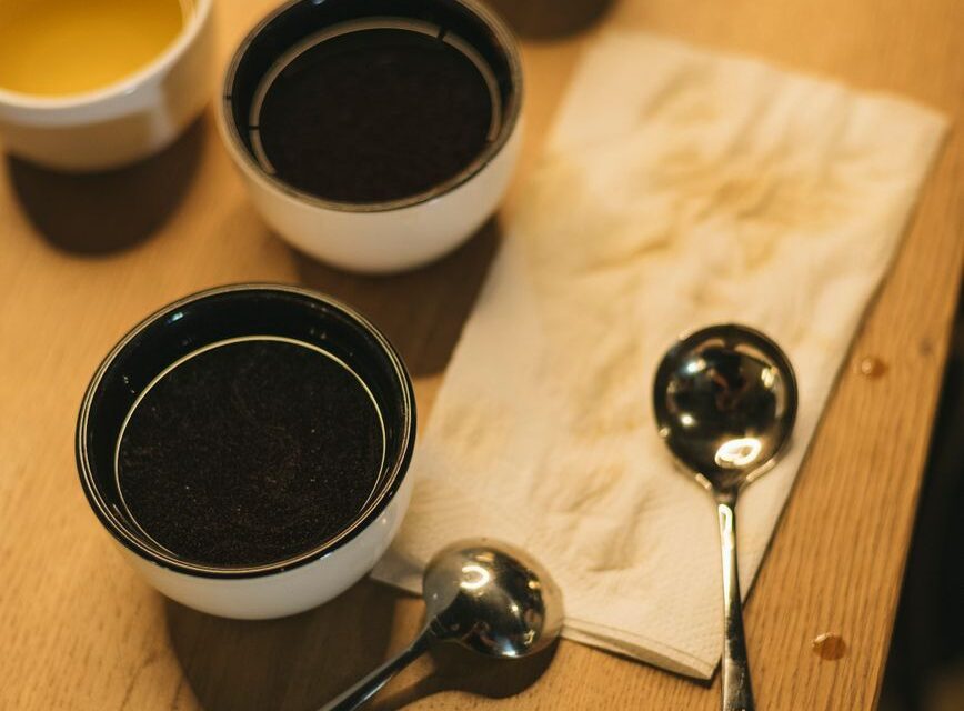 coffee tasting setup with cups and spoons